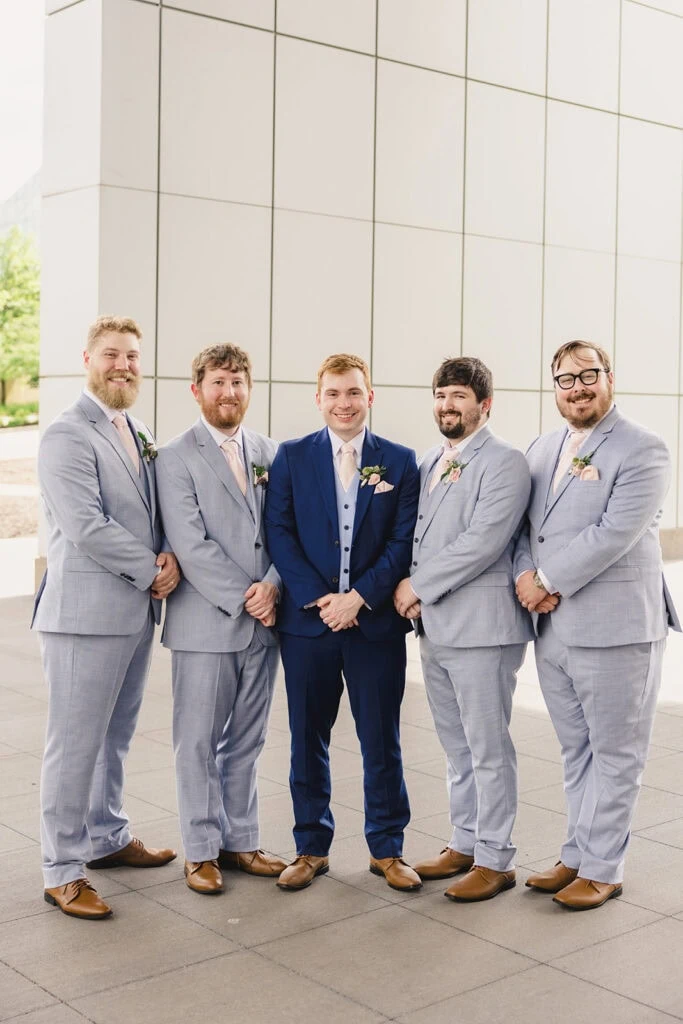 groom and groomsmen wearing blue suit rentals