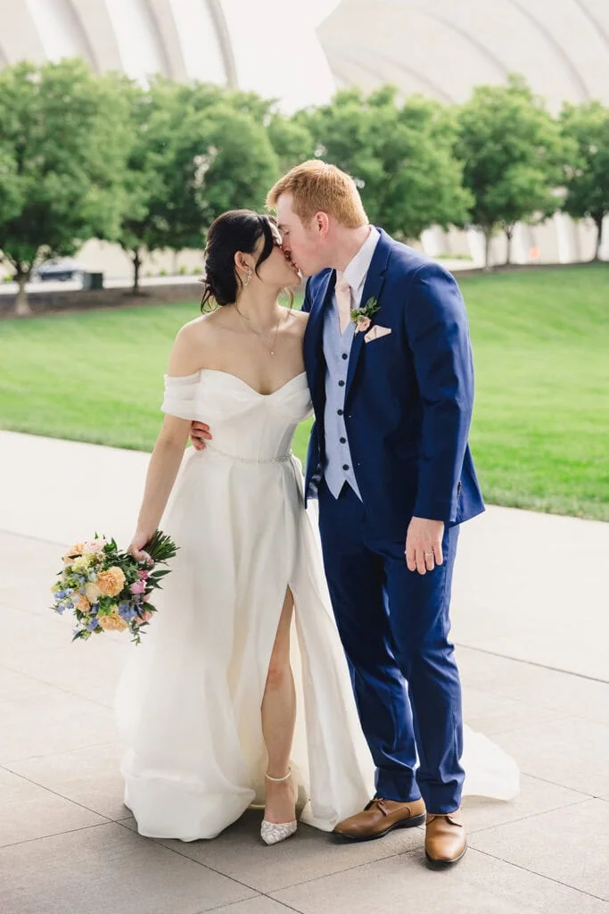 bride and groom kissing after wedding