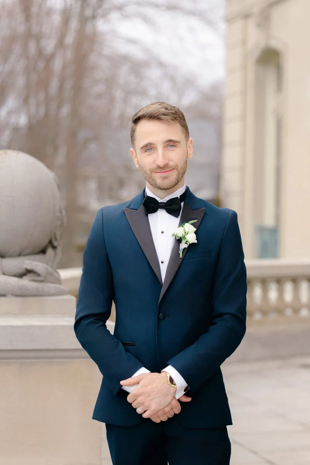 navyvenice groom wearing a navy tuxedo rental with black peak lapel