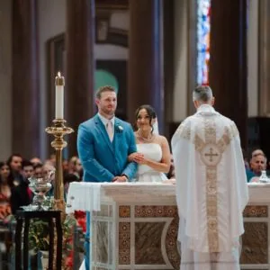 groom in blue suit getting married