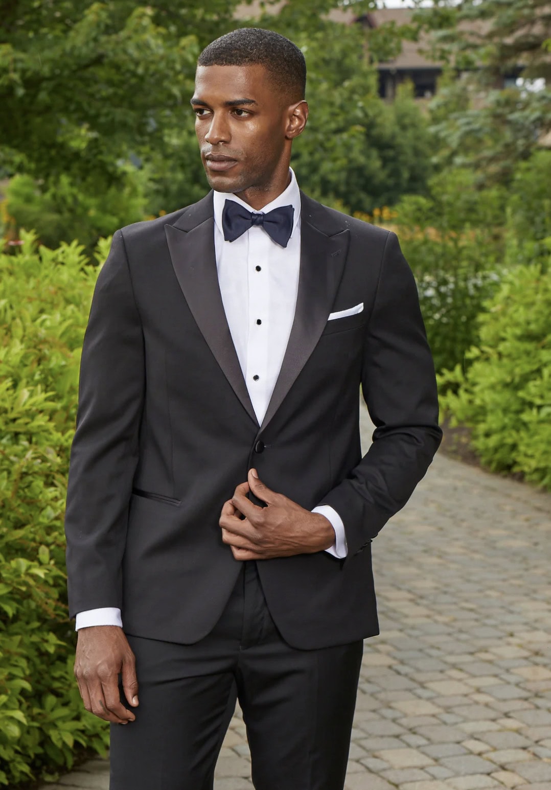 Screenshot 2025-08-26 at 21602 PM man wearing a black tuxedo with a peak lapel