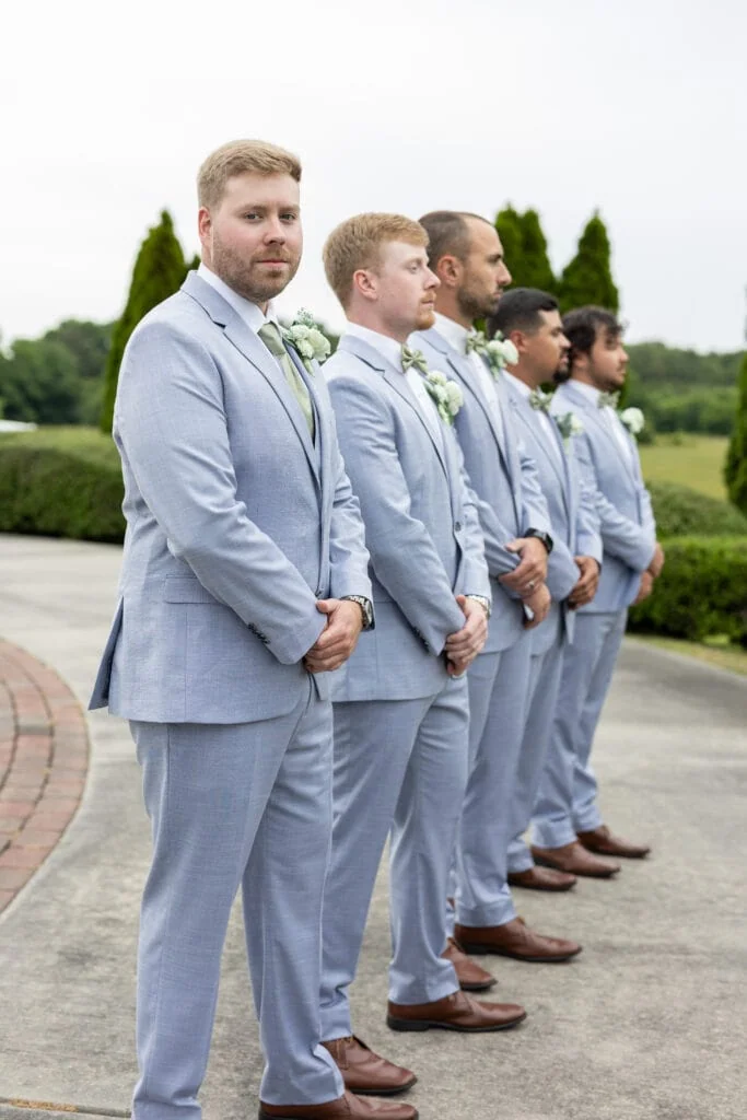 groom and groomsmen wearing blue suit rental