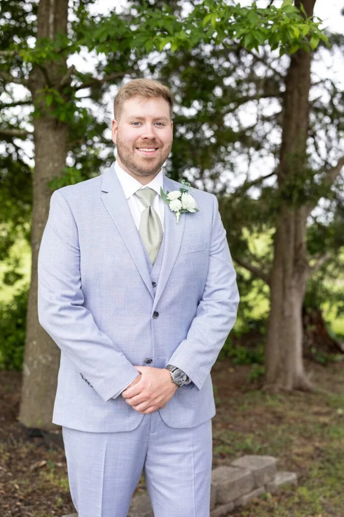 groom wearing blue suit rental