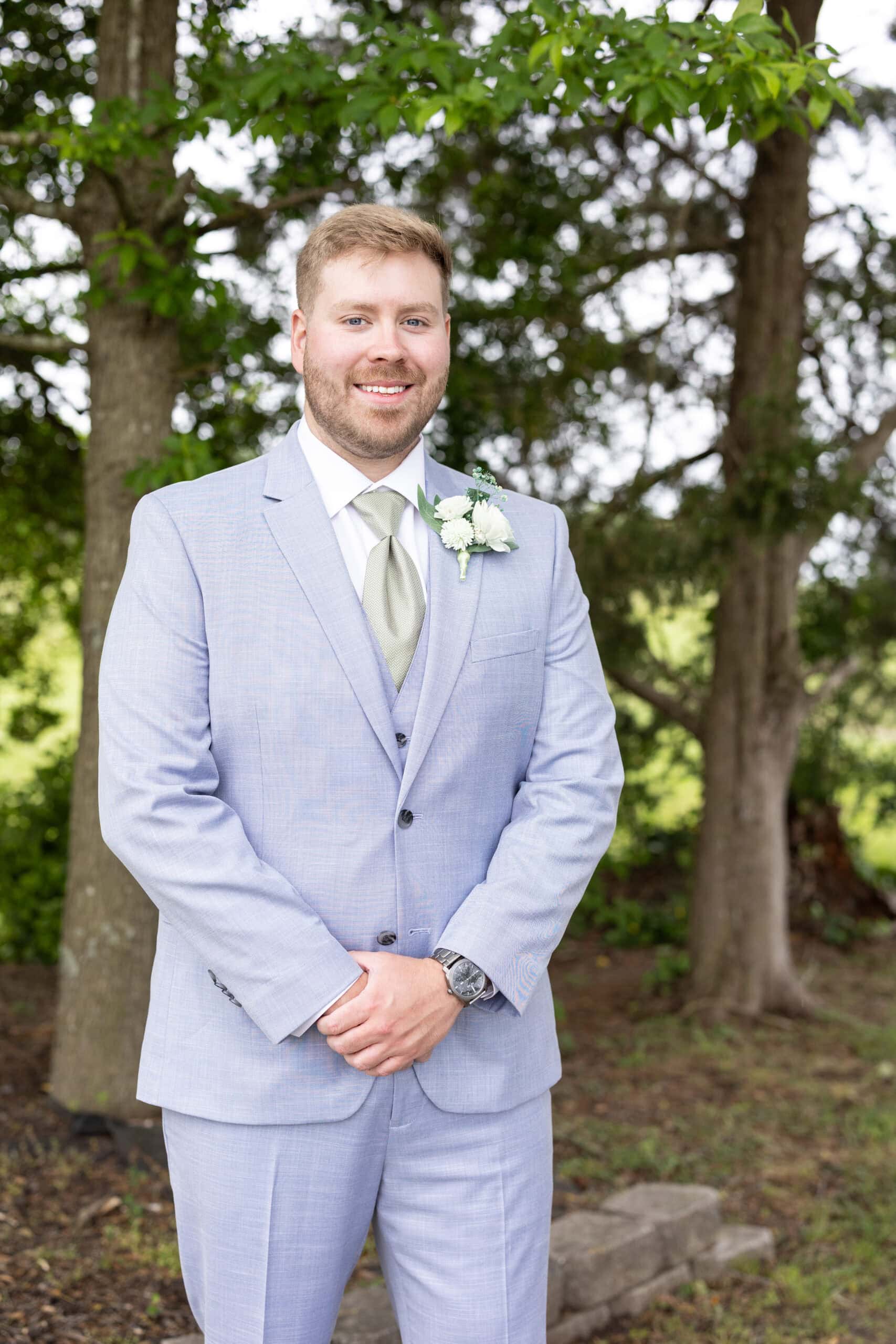 groom wearing blue suit rental