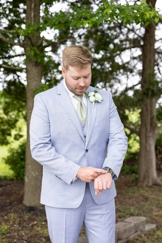 groom wearing blue suit rental