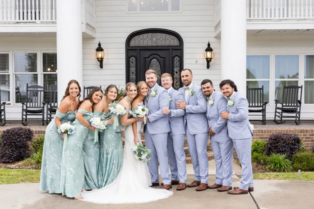wedding party wearing blue suits and green dresses