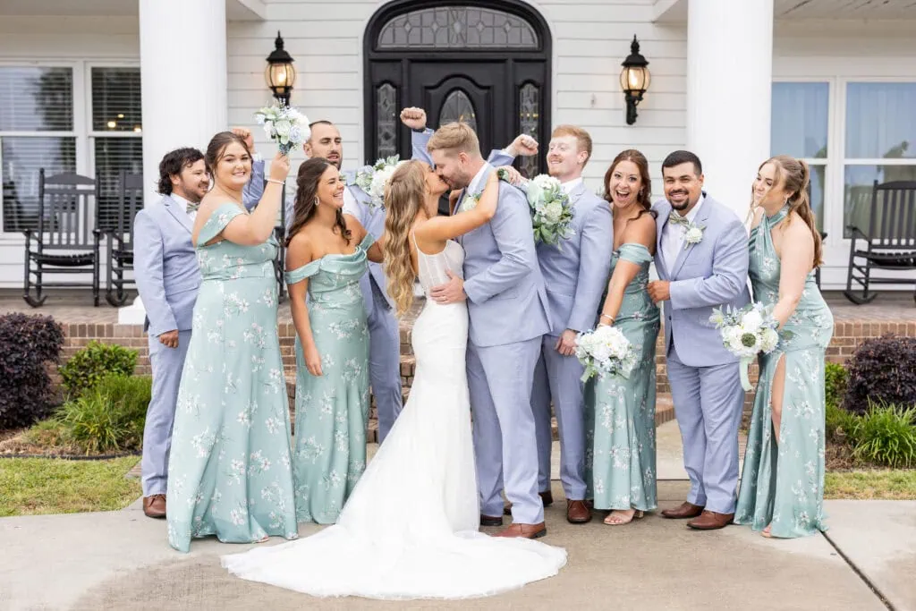 wedding party wearing blue suits and green dresses
