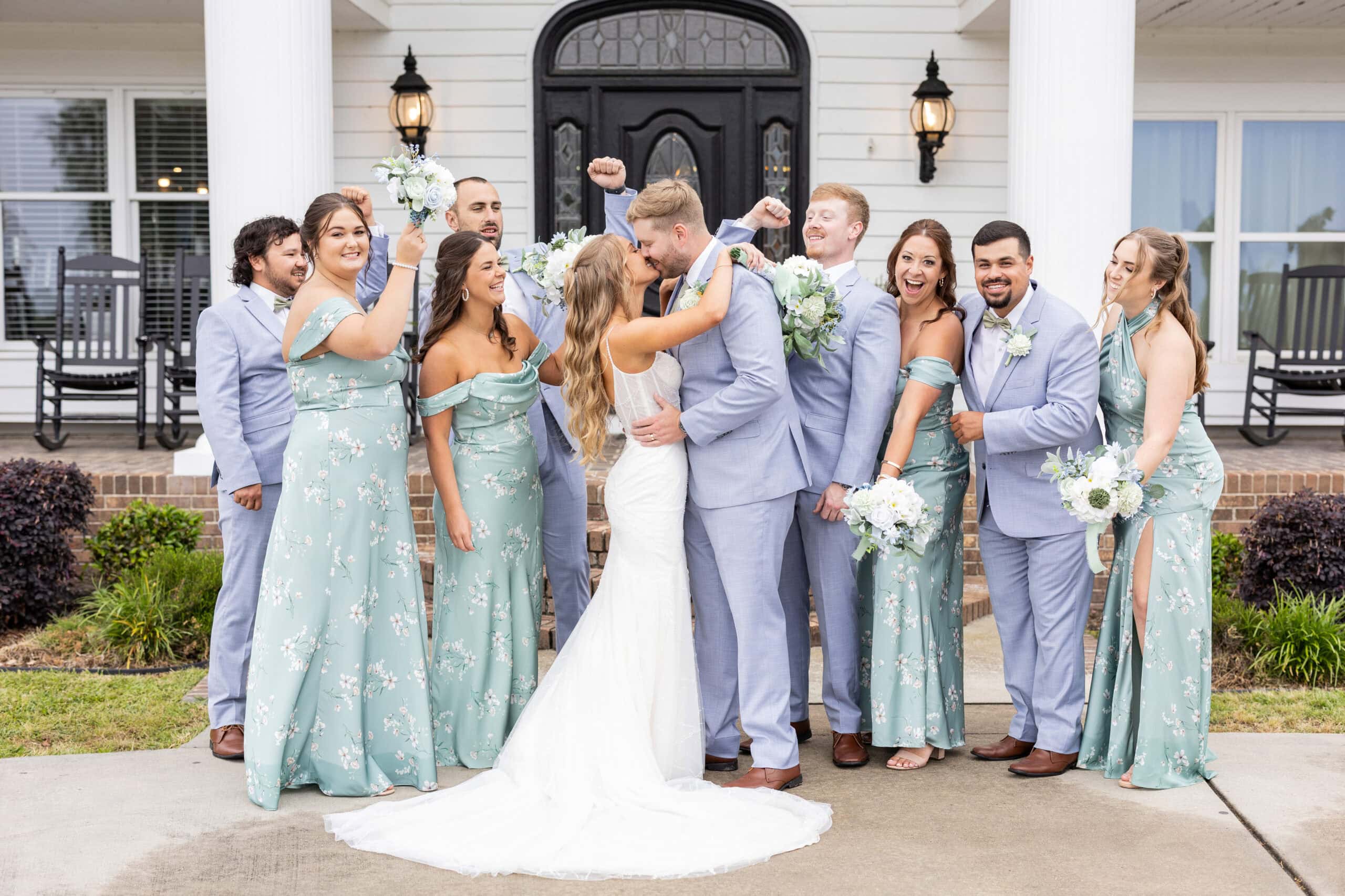 wedding party wearing blue suits and green dresses