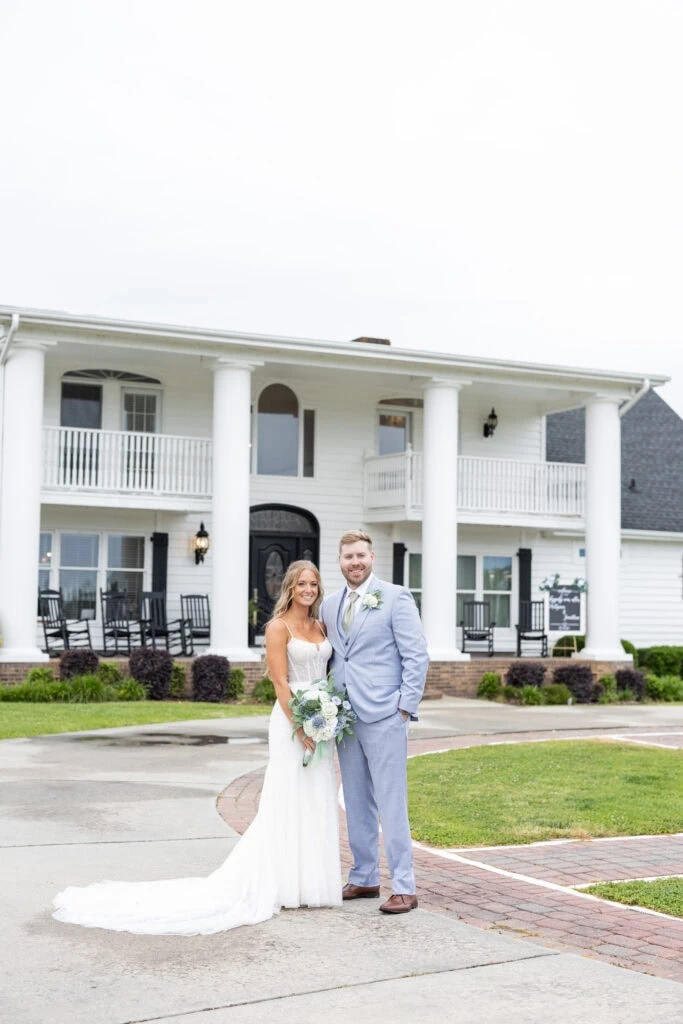 bride and groom standing outside of while building
