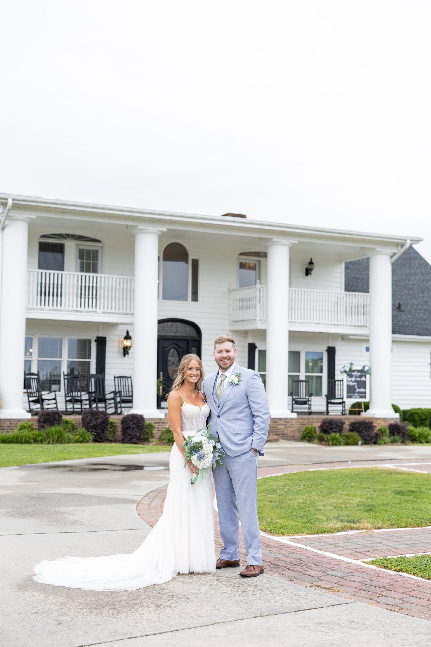 bride and groom standing outside of while building