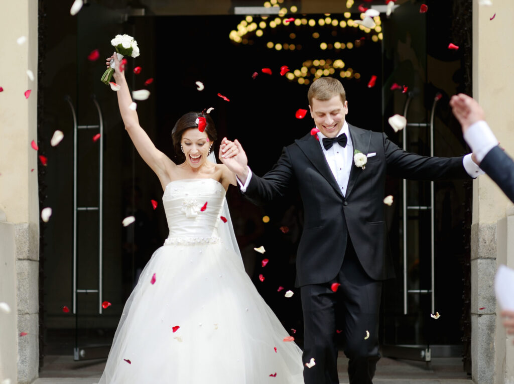 happy bride and groom exiting their wedding