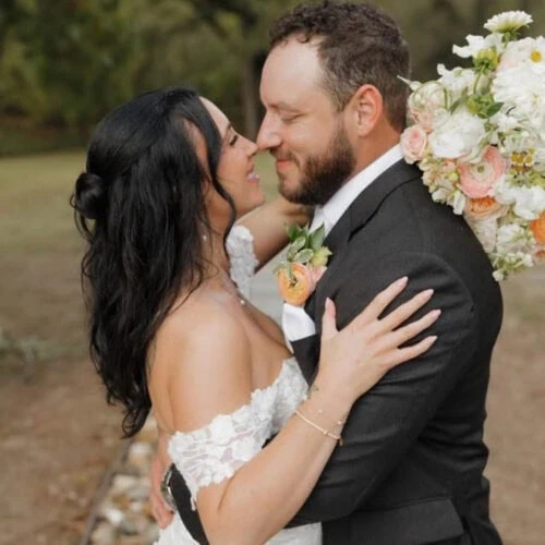 groom wearing steel grey suit with bride