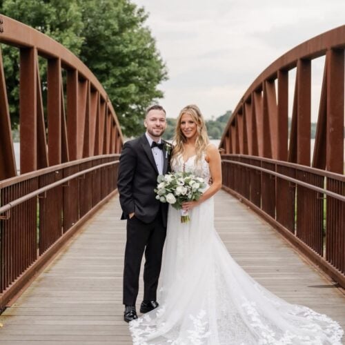 bride and groom on bridge