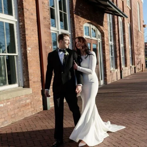 bride and groom walking down a street