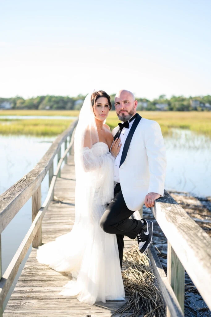 man wearing Ivory groom tuxedo on bridge