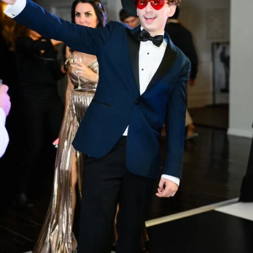 young man in navy tuxed rental