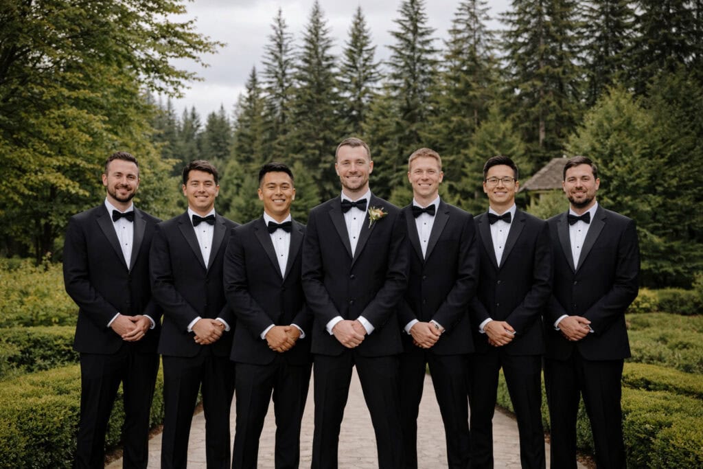 group of groomsmen wearing black tuxedos