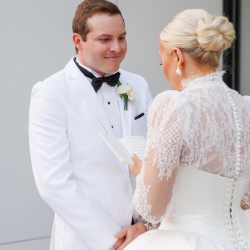 groom wearing white tuxedo rental