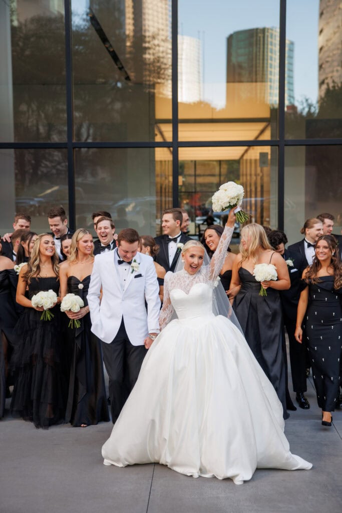 happy bride and groom with wedding party
