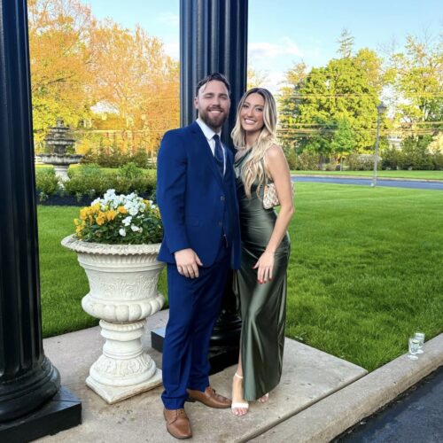 man wearing cobalt blue suit posing with date