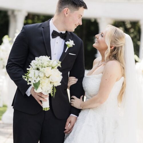 groom wearing black infinity tuxedo with bride