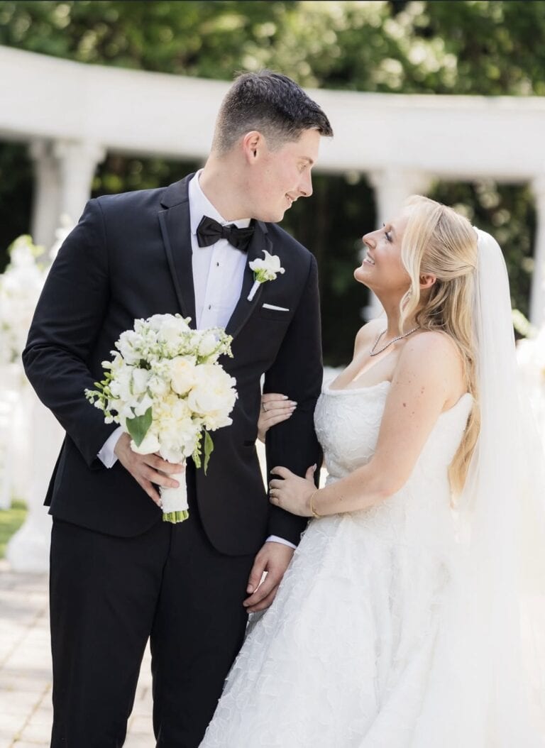 groom wearing black infinity tuxedo with bride