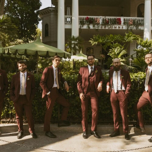 groomsmen in burgundy suits