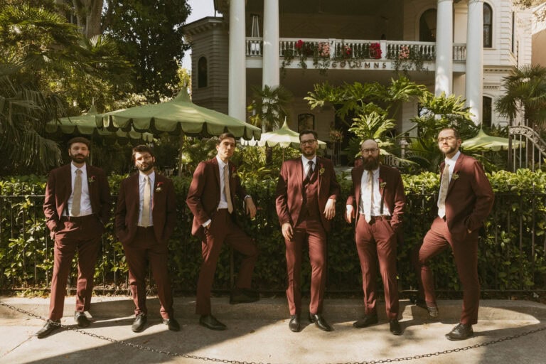 groomsmen in burgundy suits